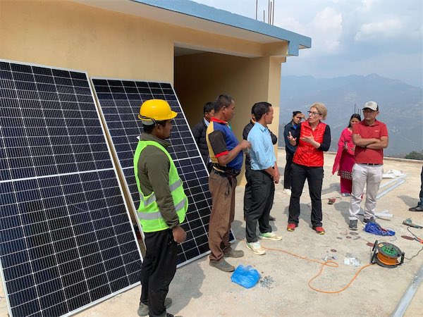 School head inspection of solar panels.